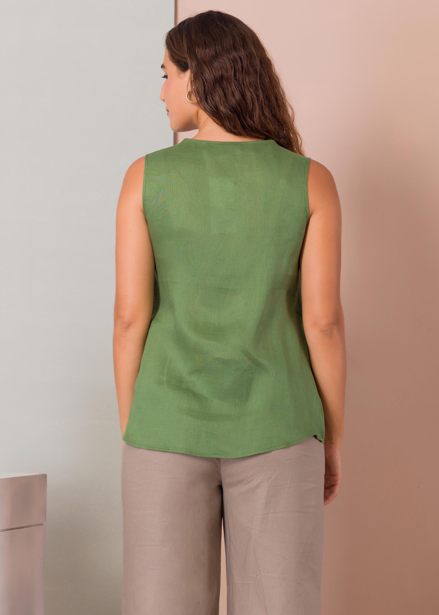 Sleeveless blouse with mock cross over panel